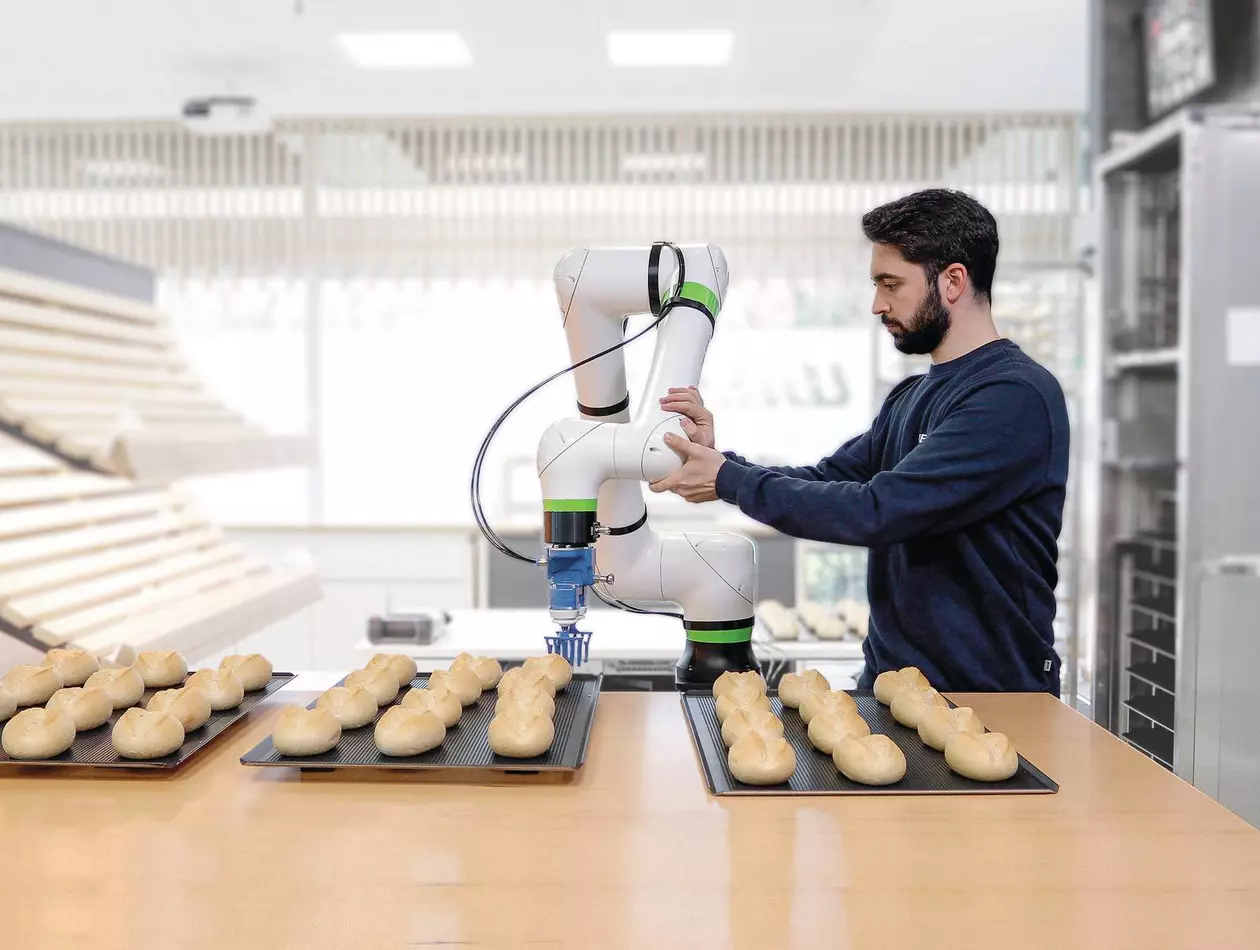 Employee collaborating with FANUC CRX robot