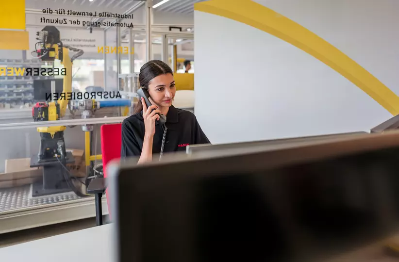 Human resources / apprentice photo with person. Woman at a desk on the phone. Landscape. High resolution.