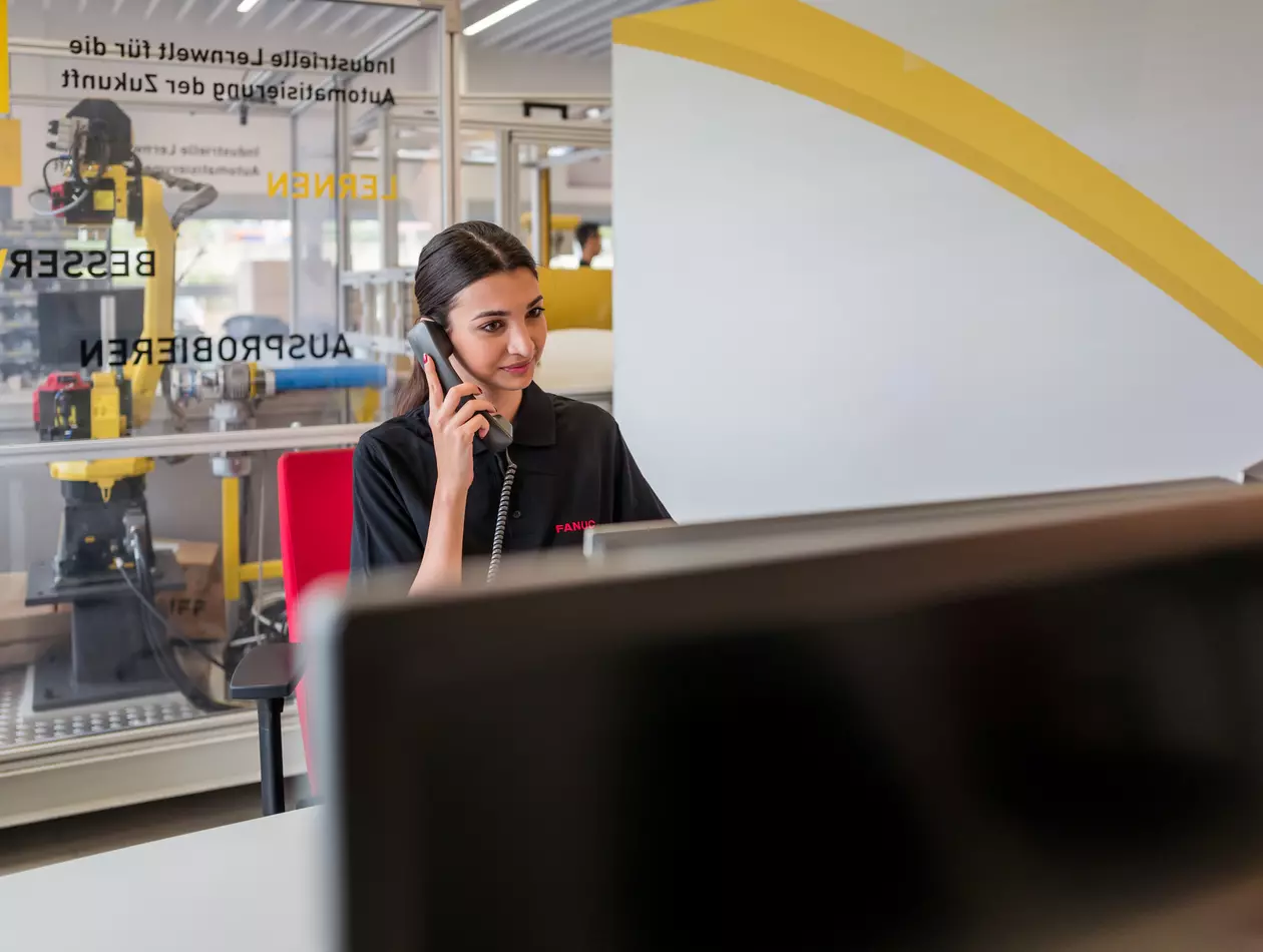 Human resources / apprentice photo with person. Woman at a desk on the phone. Landscape. High resolution.