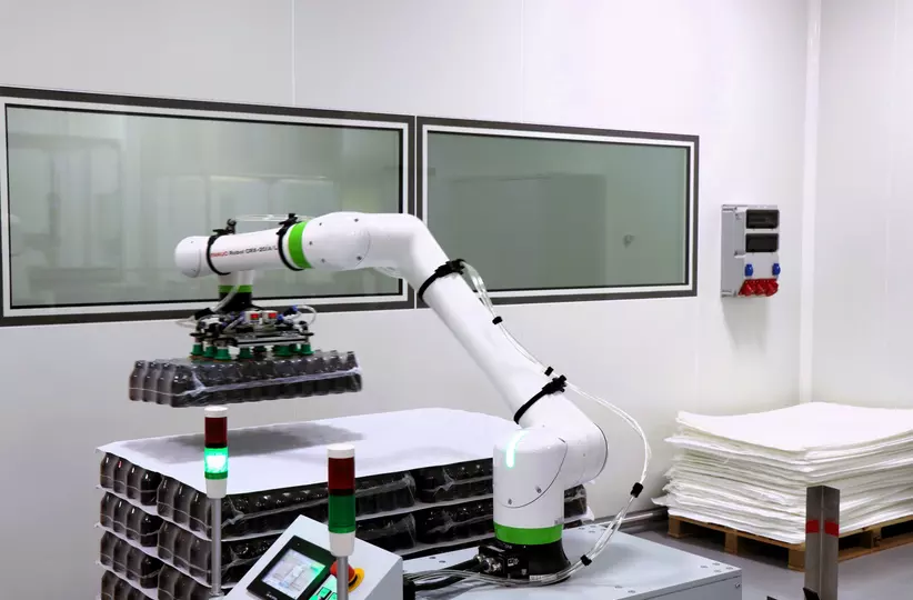 Images case study Phytopharm Klęka S.A from FPL. CRX-20iA/L handles bottle stacks using a custom vacuum gripper, while a CRX-25iA palletises heavy product cartons.