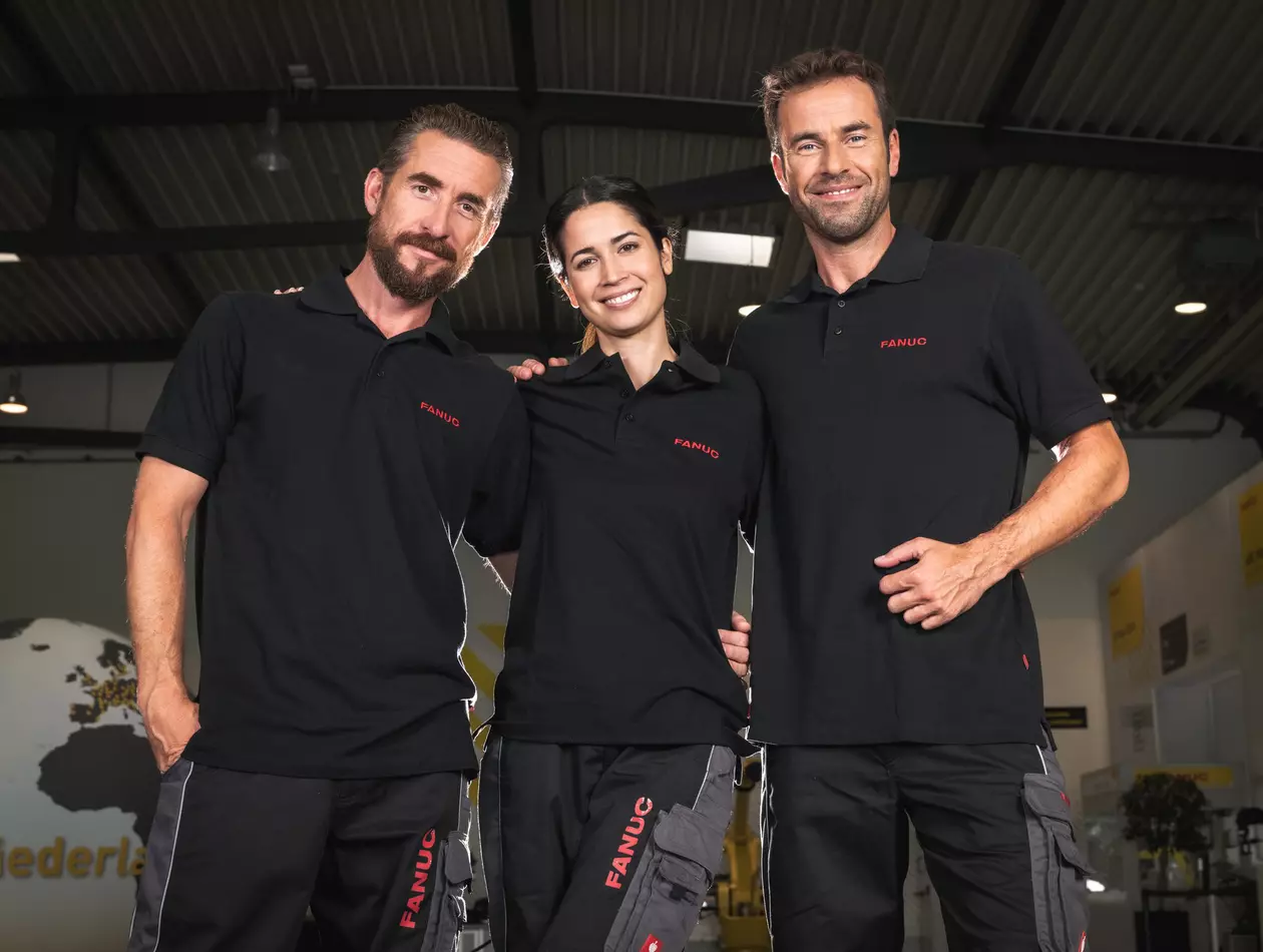 Three FANUC employees standing