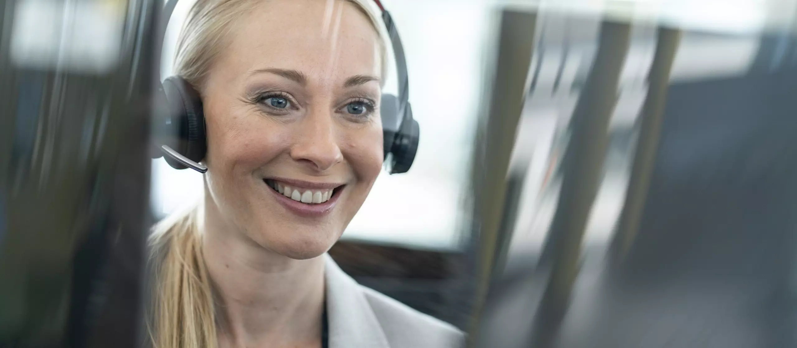 FANUC employee with headset at desk. Smiling.
Service,  service