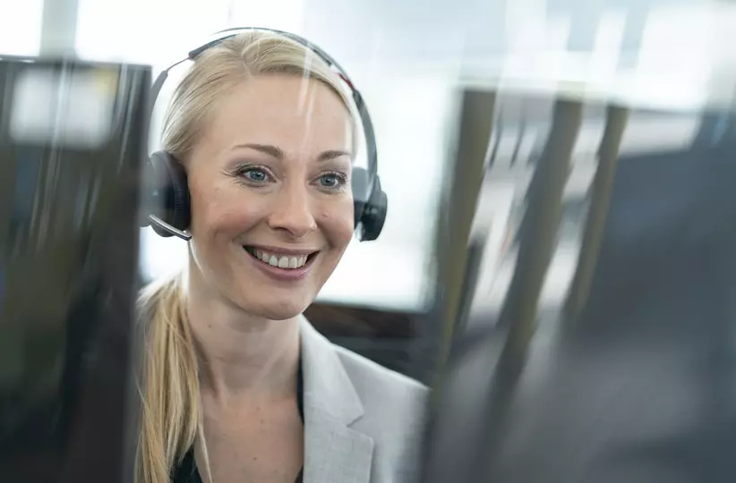 FANUC employee with headset at desk. Smiling.
Service,  service