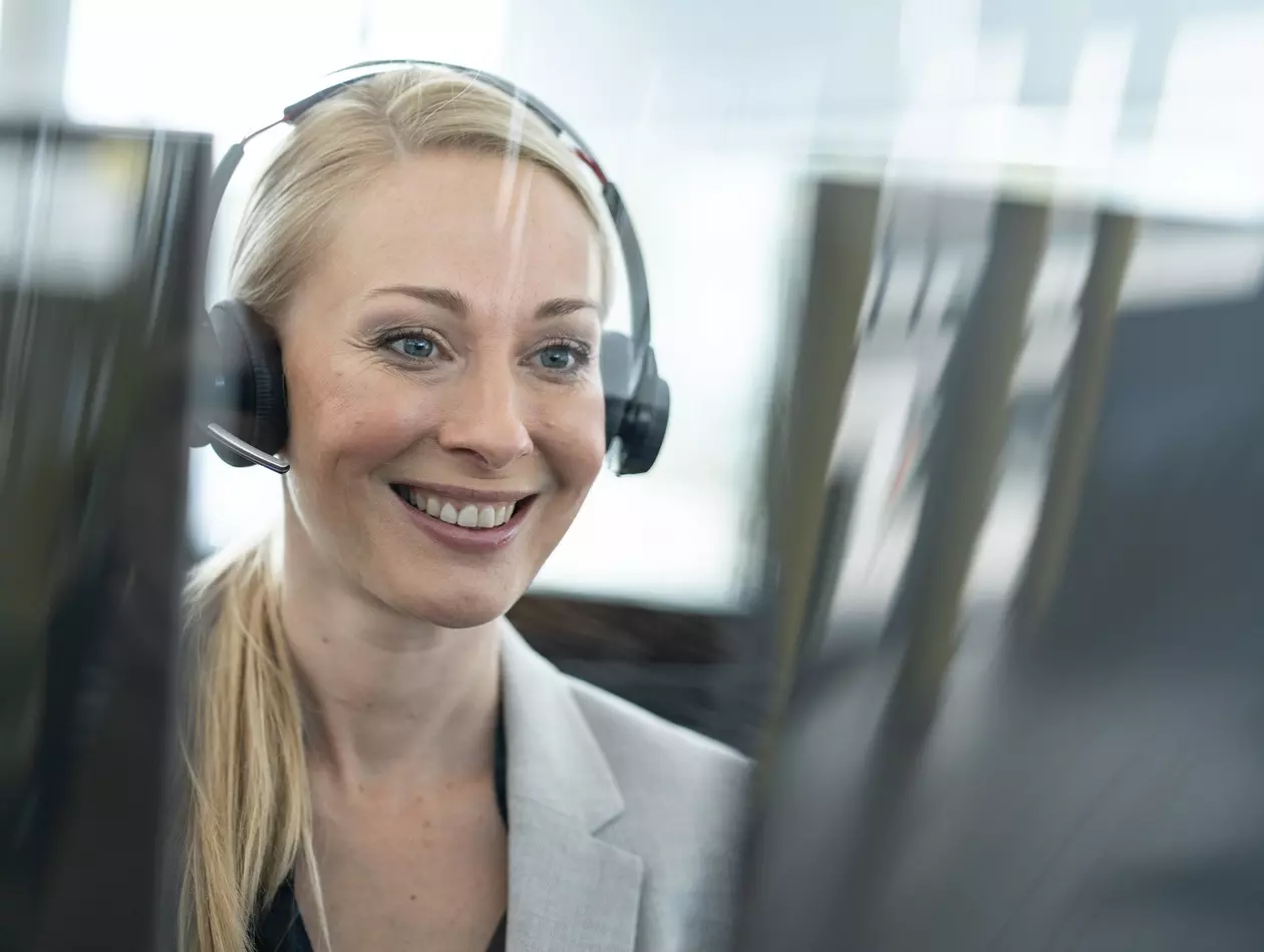 FANUC employee with headset at desk. Smiling.
Service,  service