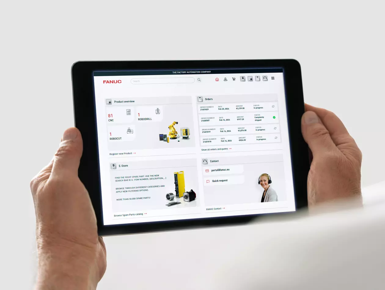 Image of FANUC Portal. 
Hands holding a tablet showing FANUC Portal home screen (product overview, orders, E-Store, Contact)