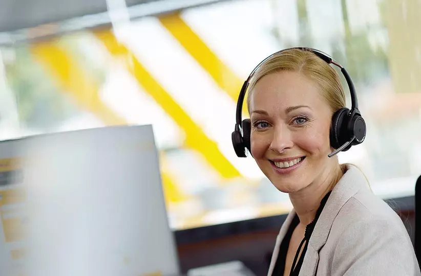 FANUC employee with headset at desk..