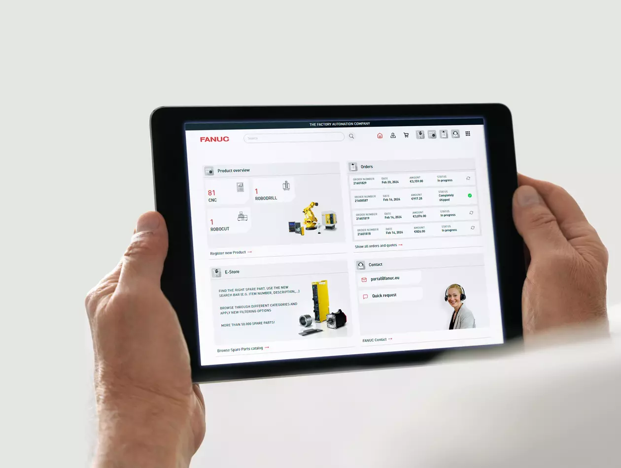 Image of FANUC Portal. 
Hands holding a tablet showing FANUC Portal home screen (product overview, orders, E-Store, Contact)
