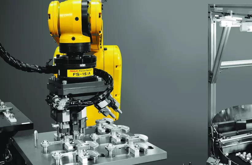 FANUC robot with FS-15iA Force Sensor fiiting and inserting parts.